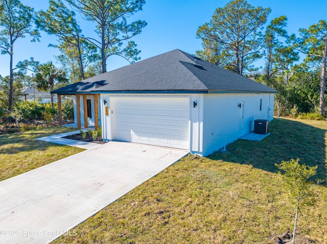 view of front of property featuring central AC, a garage, and a front yard