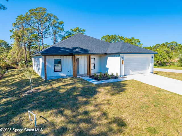 view of front of property featuring a front yard and a garage