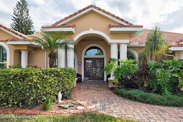 view of exterior entry featuring french doors