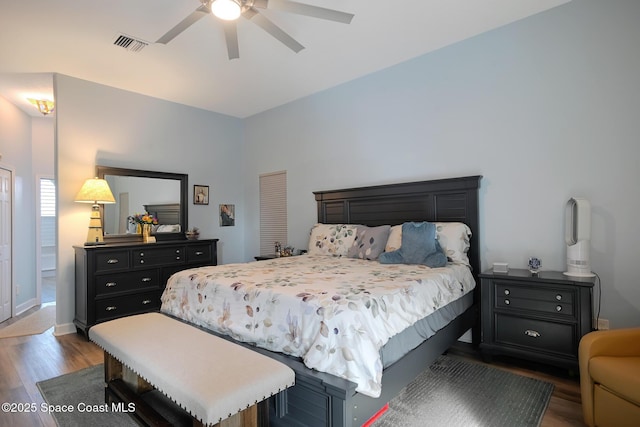 bedroom with dark hardwood / wood-style flooring and ceiling fan