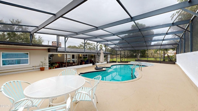 view of pool with a patio and glass enclosure