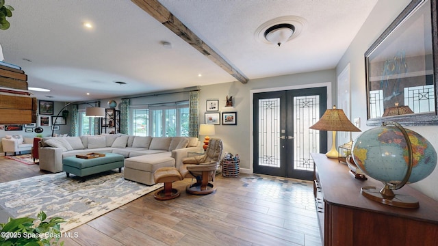 entryway with beam ceiling, wood-type flooring, french doors, and a textured ceiling