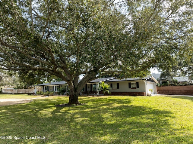 view of front of property with a garage and a front lawn