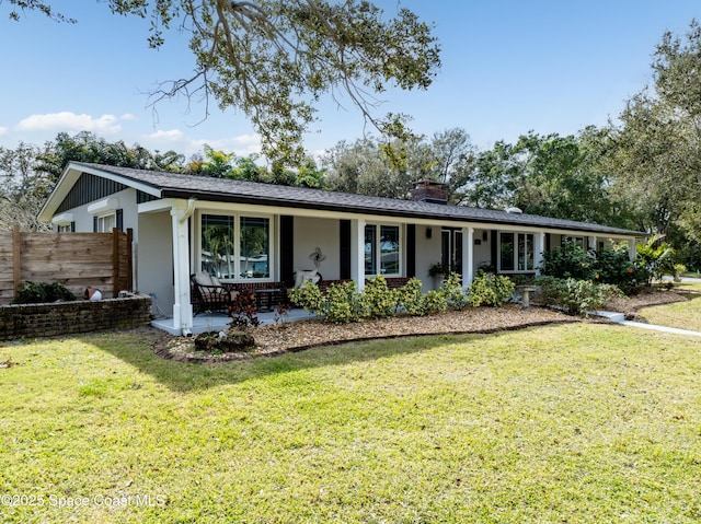 ranch-style house with covered porch and a front yard