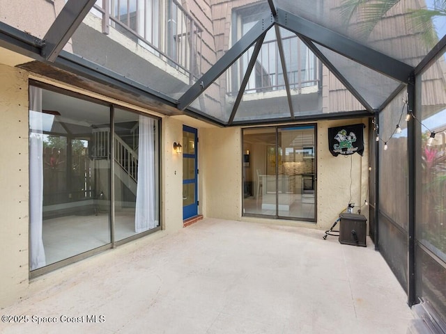 unfurnished sunroom featuring lofted ceiling