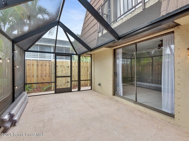 unfurnished sunroom featuring lofted ceiling