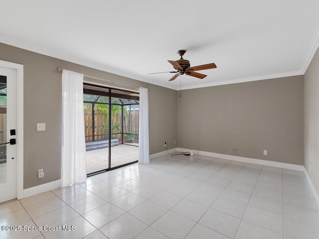 tiled empty room featuring ceiling fan and ornamental molding