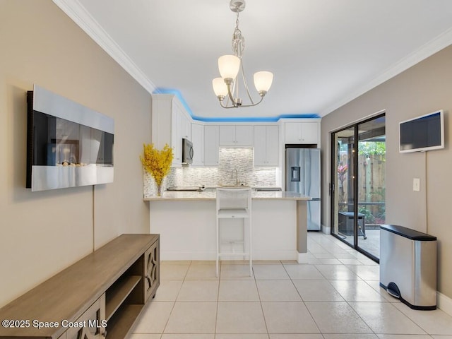 kitchen with appliances with stainless steel finishes, white cabinetry, backsplash, ornamental molding, and light stone counters