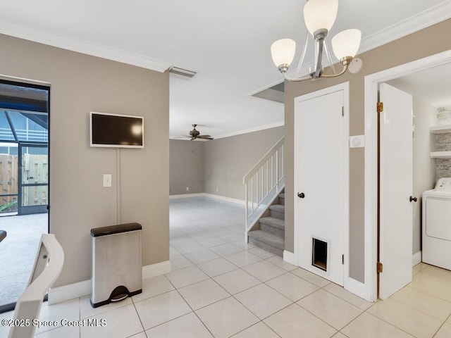 interior space with a notable chandelier, washer / dryer, crown molding, and light tile patterned flooring