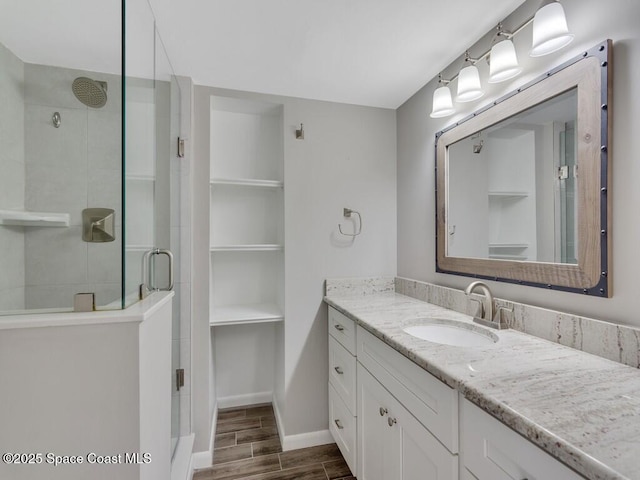 bathroom featuring walk in shower and vanity