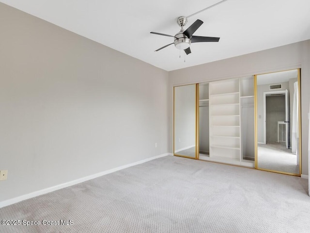 unfurnished bedroom with light carpet, a closet, and ceiling fan