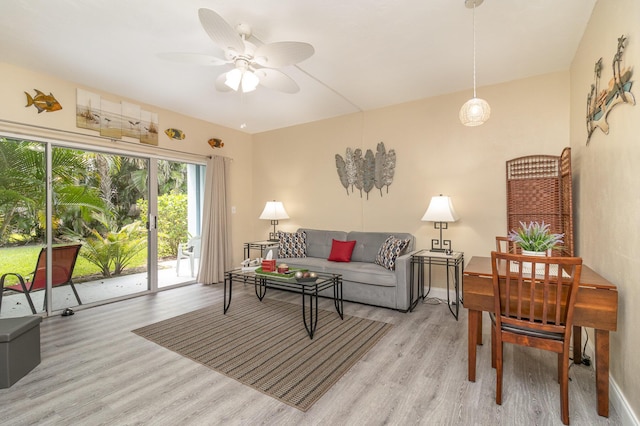 living room featuring light wood-type flooring and ceiling fan