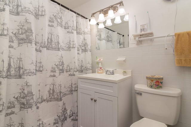 bathroom featuring tile walls, toilet, vanity, and a shower with shower curtain