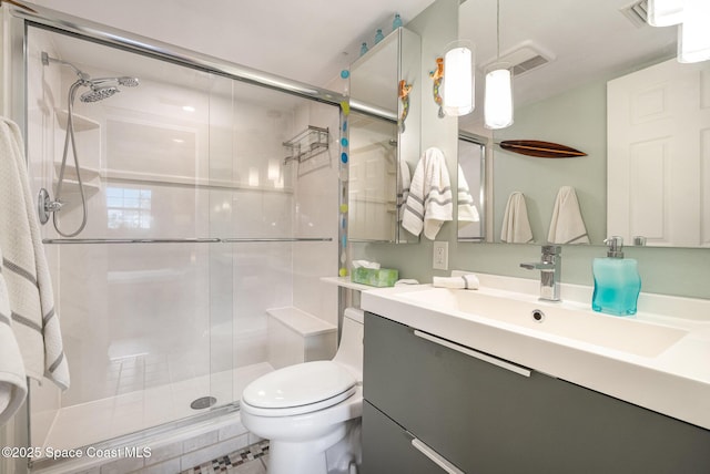 bathroom with an enclosed shower, vanity, and toilet