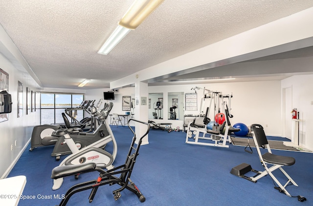 exercise room with a textured ceiling