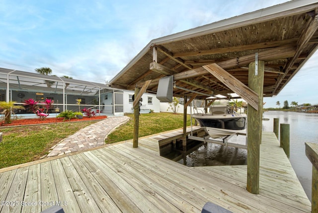 view of dock featuring a lawn, glass enclosure, and a water view