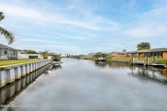 view of dock with a water view and a yard