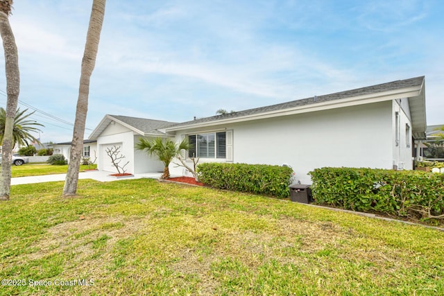 ranch-style home with a garage and a front lawn