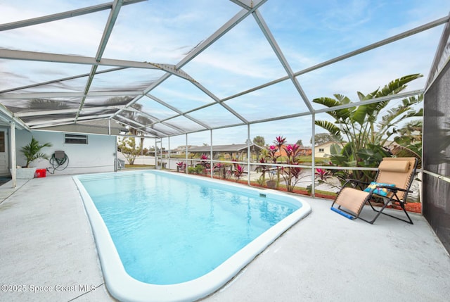 view of pool with a lanai and a patio