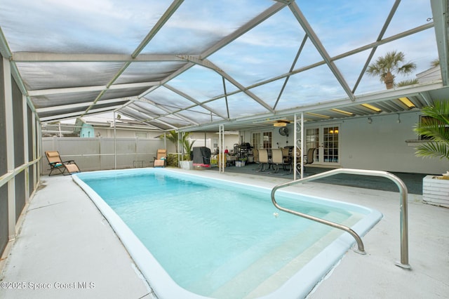 view of pool featuring a patio and glass enclosure