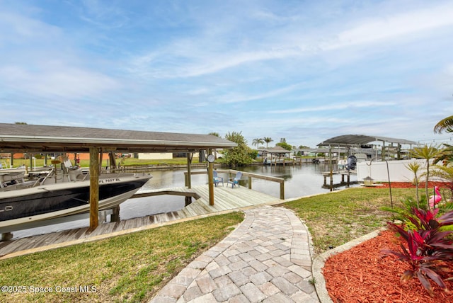 dock area featuring a water view and a yard