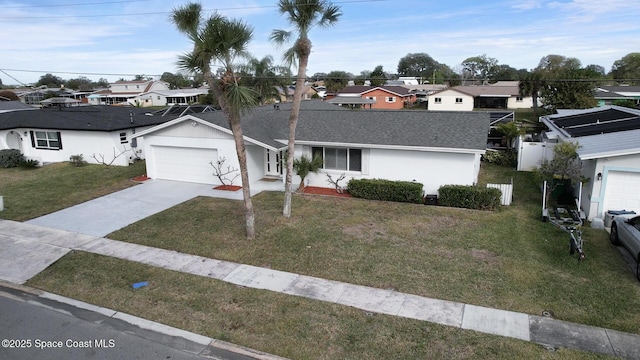 single story home featuring a garage and a front lawn