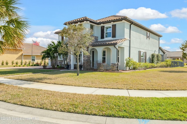 mediterranean / spanish-style home featuring a front lawn