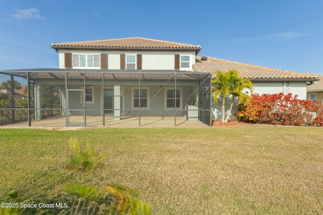 rear view of house featuring a lanai, a patio area, and a lawn