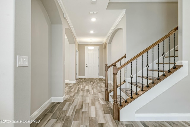 entrance foyer featuring hardwood / wood-style flooring and ornamental molding