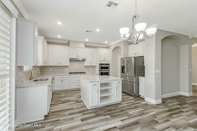 kitchen featuring appliances with stainless steel finishes, a center island, sink, and white cabinets