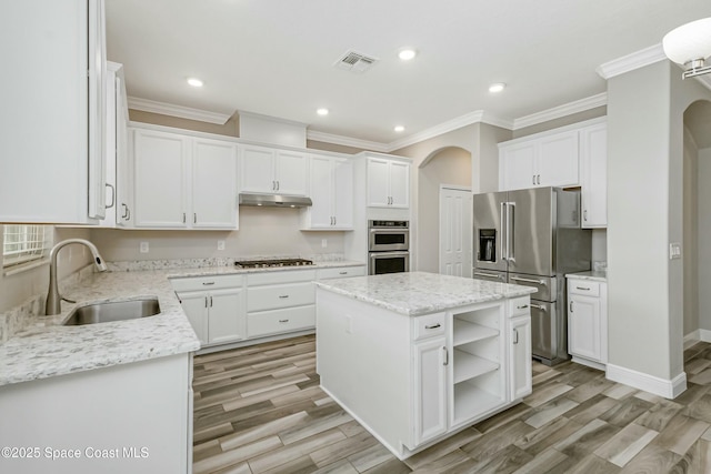 kitchen featuring a kitchen island, appliances with stainless steel finishes, sink, white cabinets, and light hardwood / wood-style flooring