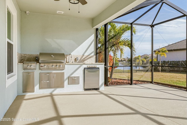 unfurnished sunroom with a water view, sink, and ceiling fan