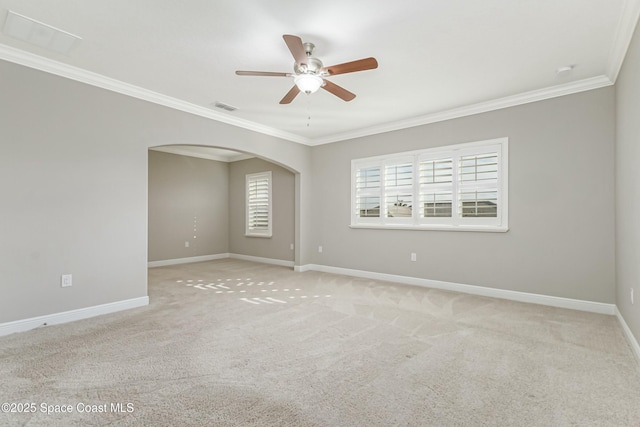 carpeted empty room with ceiling fan and ornamental molding