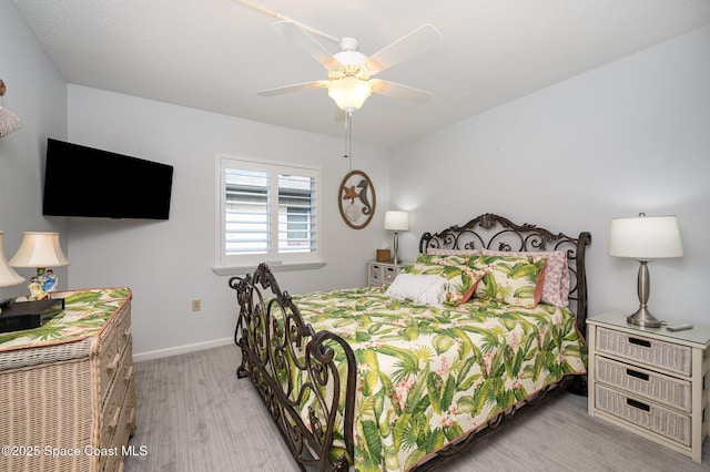 bedroom with ceiling fan and light wood-type flooring