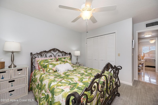 bedroom with ceiling fan, light hardwood / wood-style floors, and a closet