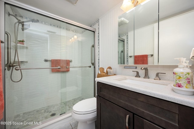 bathroom with vanity, walk in shower, and toilet