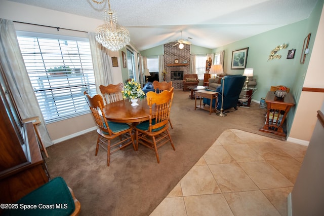 dining area featuring light carpet, a brick fireplace, a wealth of natural light, and lofted ceiling