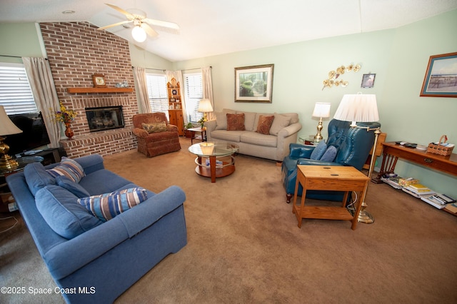 living room featuring vaulted ceiling, ceiling fan, carpet, and a fireplace