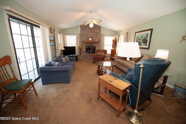 carpeted living room with ceiling fan, vaulted ceiling, and a fireplace