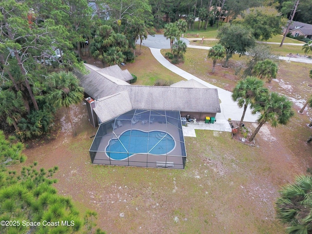 view of pool featuring a lanai, a lawn, and a patio area