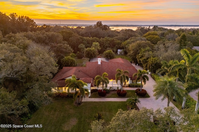 aerial view at dusk with a water view