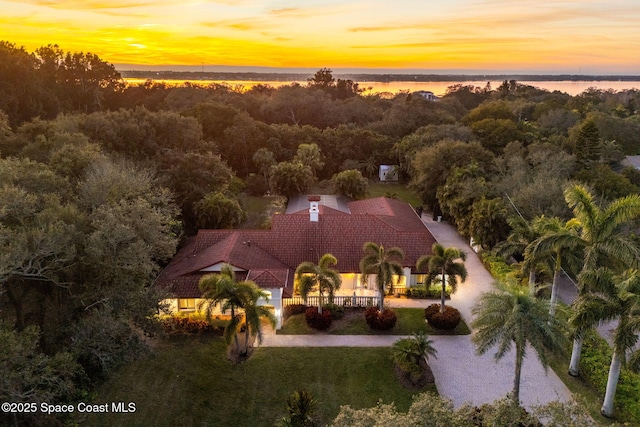 aerial view at dusk with a water view