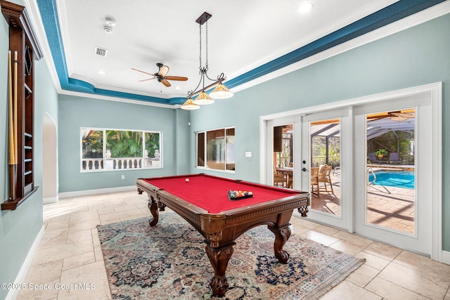 recreation room featuring a raised ceiling, crown molding, plenty of natural light, and french doors