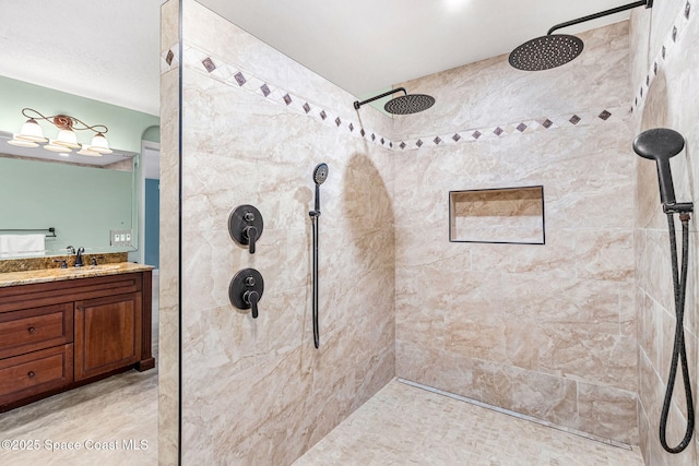 bathroom with vanity and a tile shower