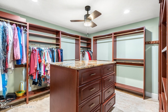 walk in closet featuring ceiling fan