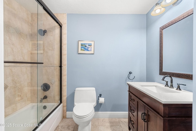 full bathroom featuring vanity, tile patterned flooring, bath / shower combo with glass door, and toilet