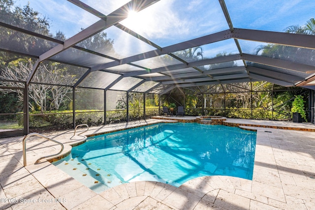 view of swimming pool featuring a lanai, a patio area, and an in ground hot tub