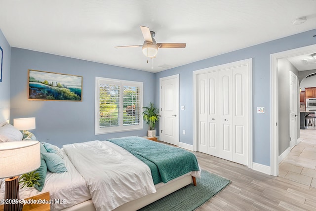 bedroom with light hardwood / wood-style flooring, a closet, and ceiling fan