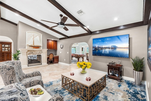 living room featuring ceiling fan and vaulted ceiling with beams