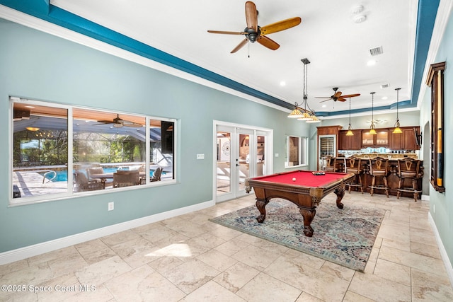 rec room featuring french doors, bar, crown molding, and a raised ceiling